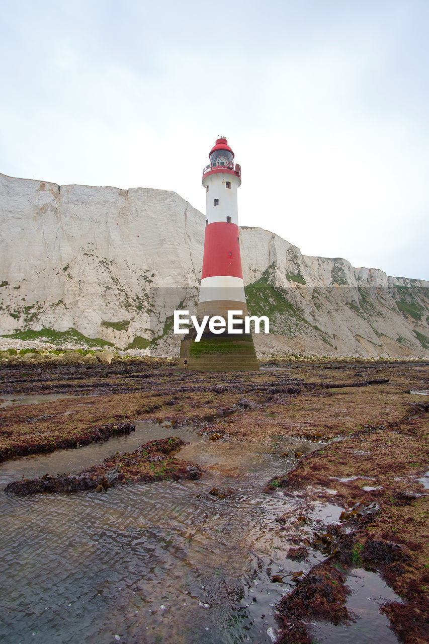 Beachy head lighthouse, seven sisters chalk cliffs at low tide near eastbourne, east sussex