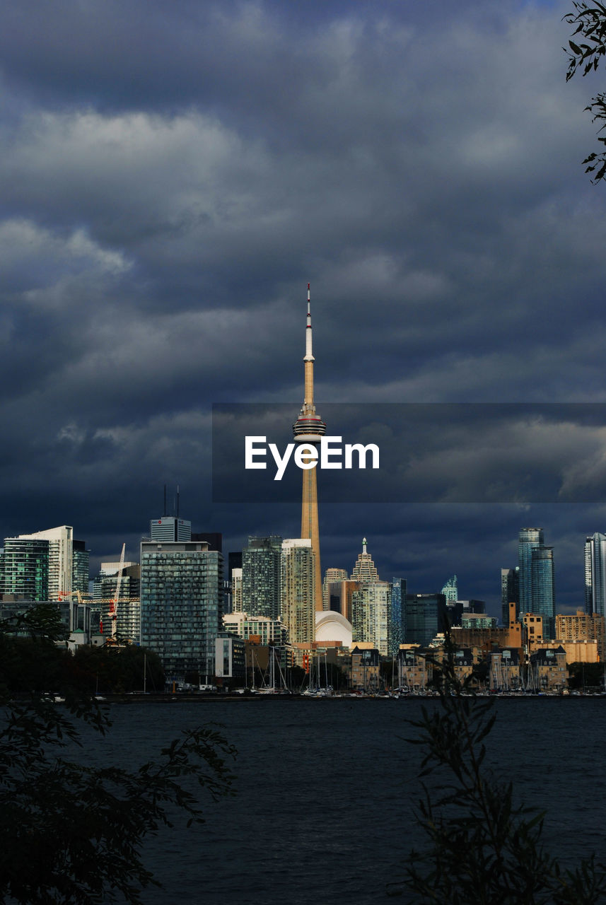 CITY BUILDINGS AGAINST CLOUDY SKY