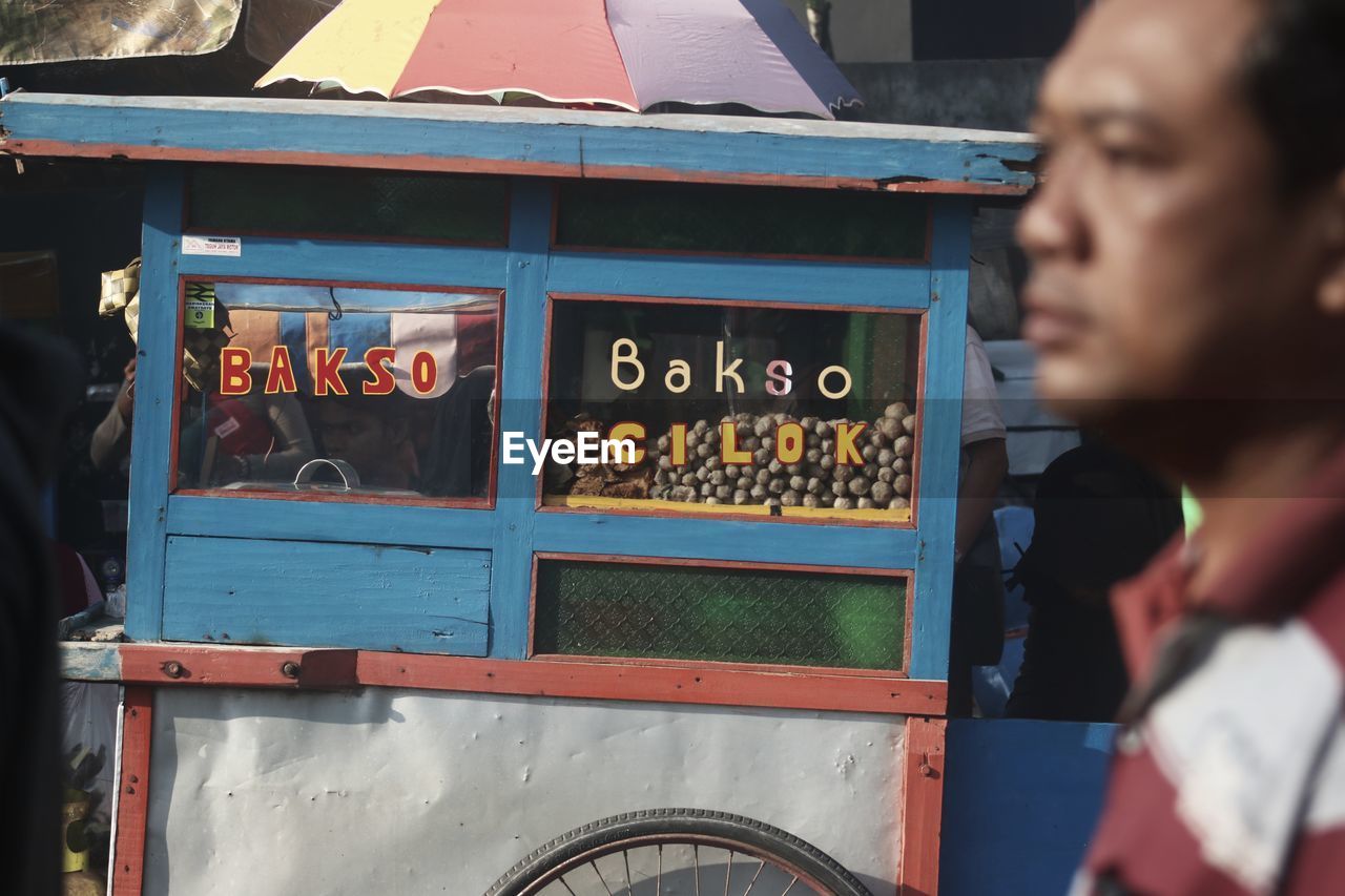 Portrait of meatball cart and my father. this photo was taken in jakarta on 4 december 2019.