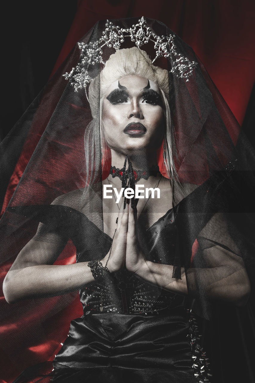 adult, women, one person, make-up, clothing, indoors, portrait, religion, celebration, female, costume, arts culture and entertainment, fashion, red, fear, human representation, gothic style, spooky, mystery, death, spirituality, black, halloween, studio shot, stage make-up, person