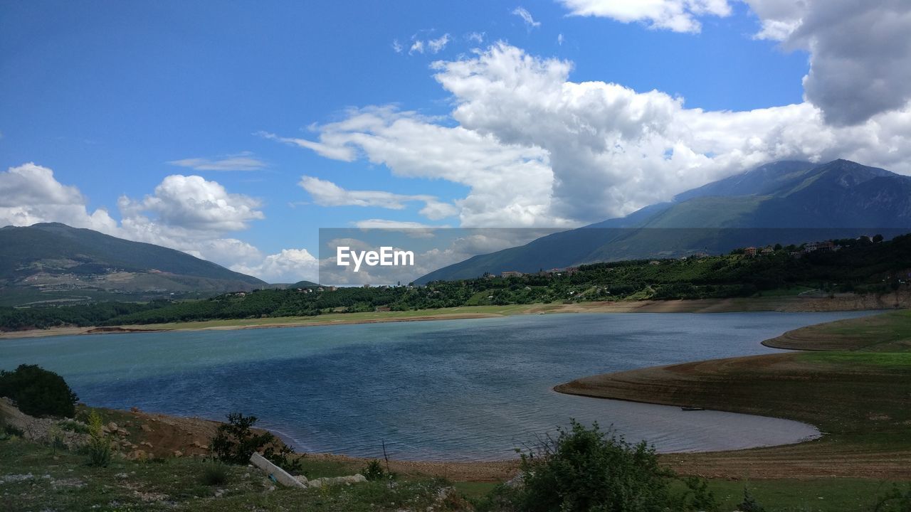 Scenic view of lake and mountains against sky