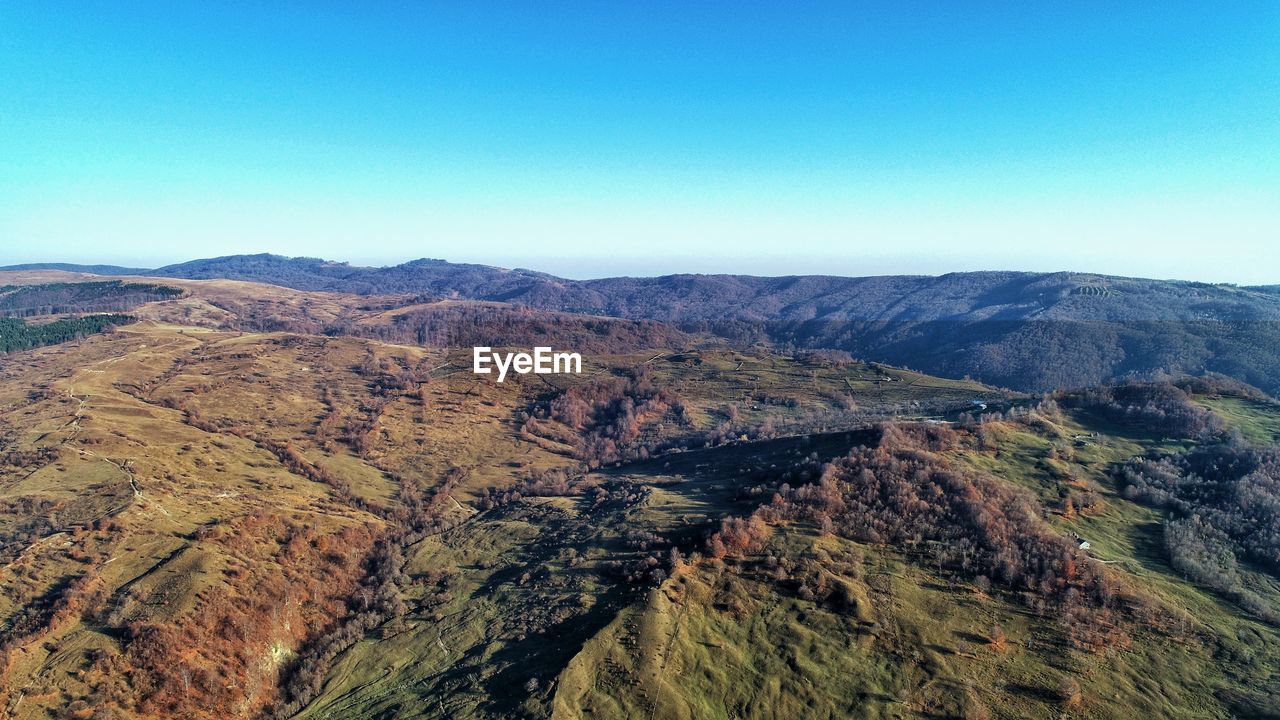 SCENIC VIEW OF MOUNTAINS AGAINST CLEAR SKY