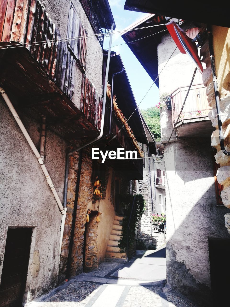 Staircase amidst houses against sky