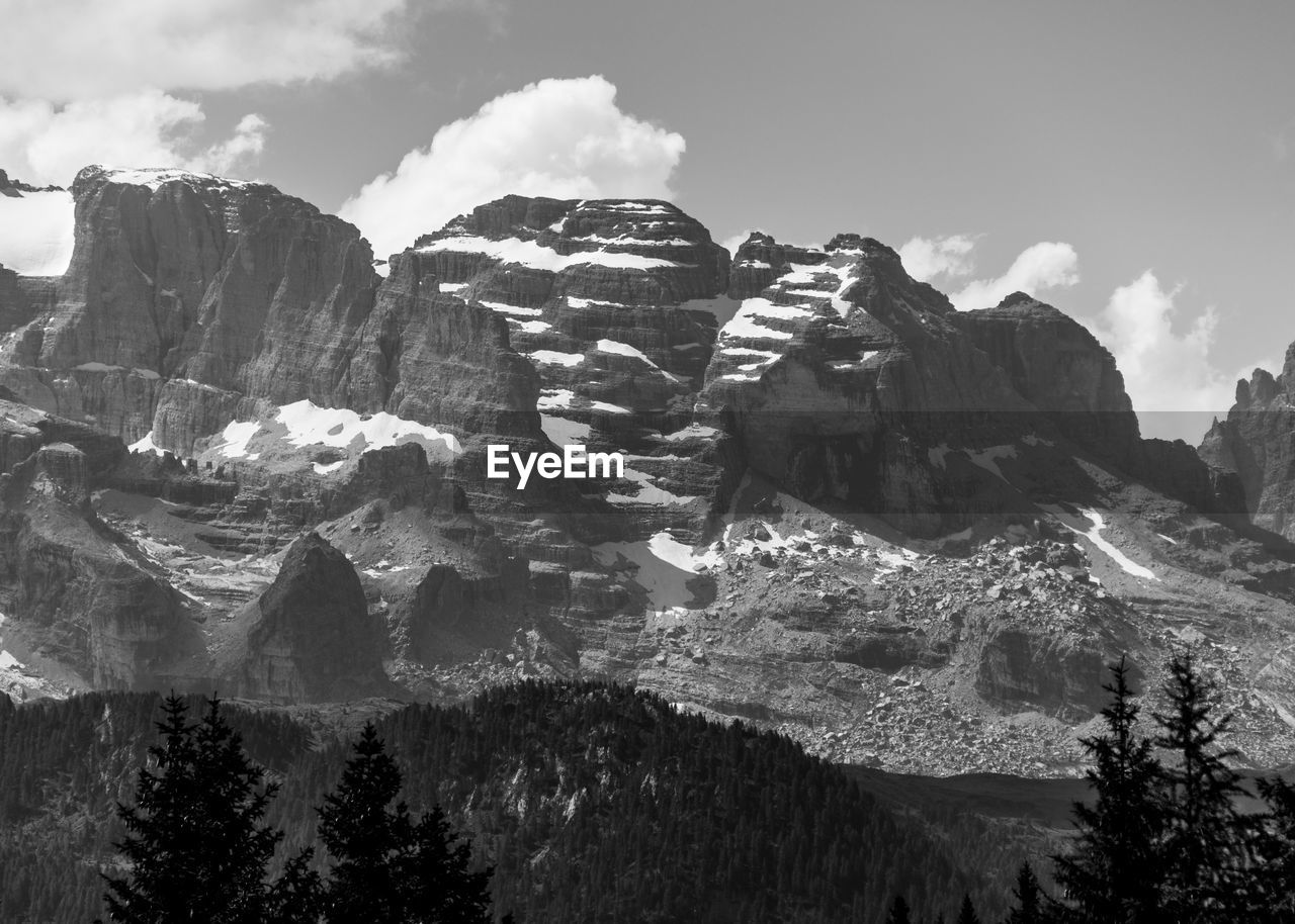 Snow capped peaks of cloud shrouded rocky mountains