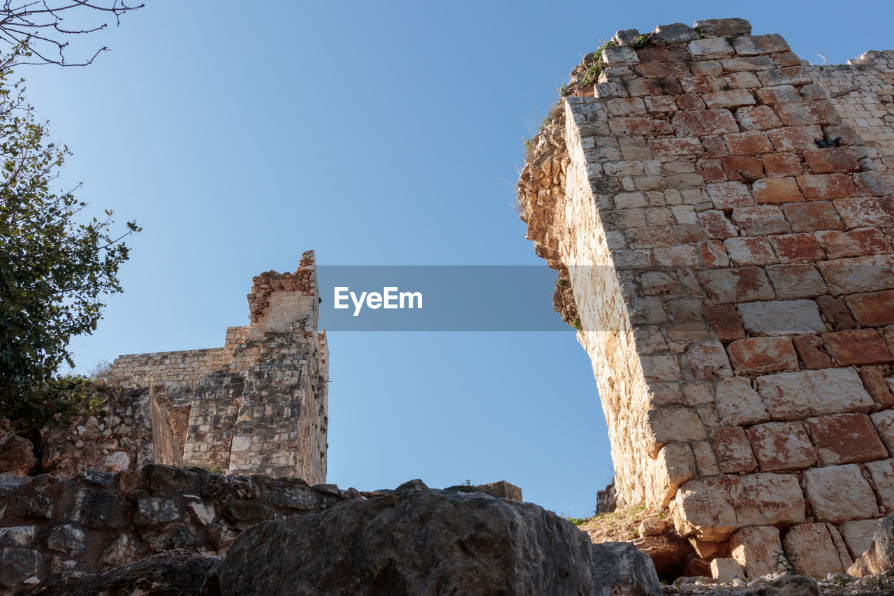 Low angle view of old ruin against clear sky
