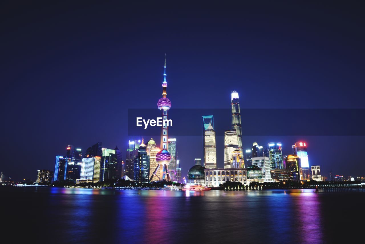 Bay against oriental pearl tower and buildings and night