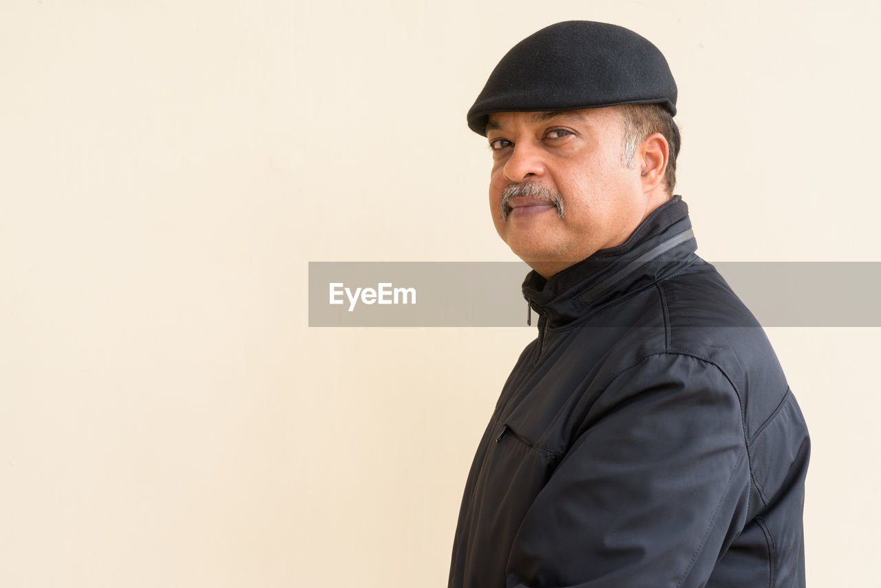 PORTRAIT OF MAN AGAINST WHITE BACKGROUND