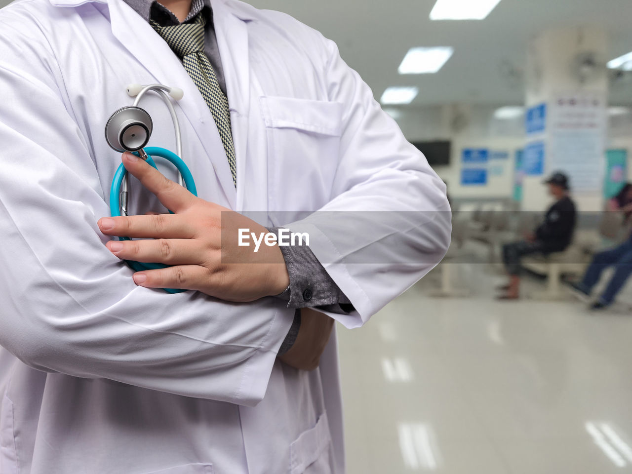 midsection of female doctor holding stethoscope