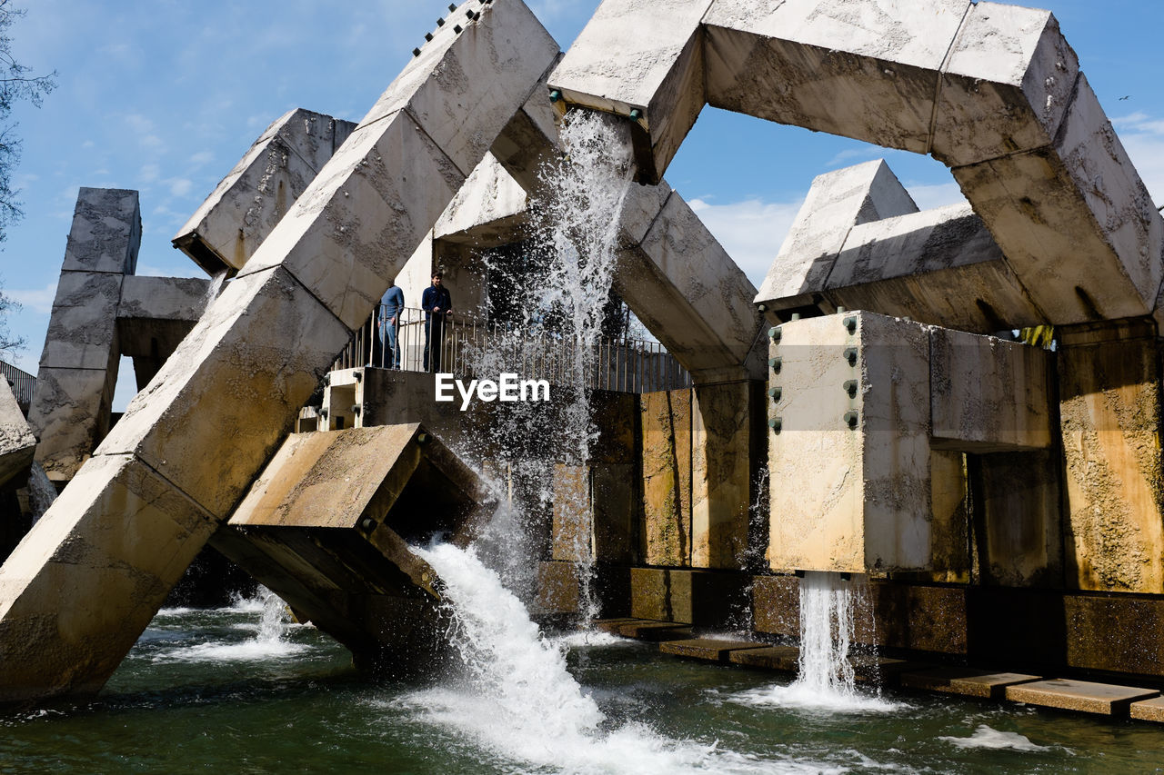 Obsolete fountains against sky