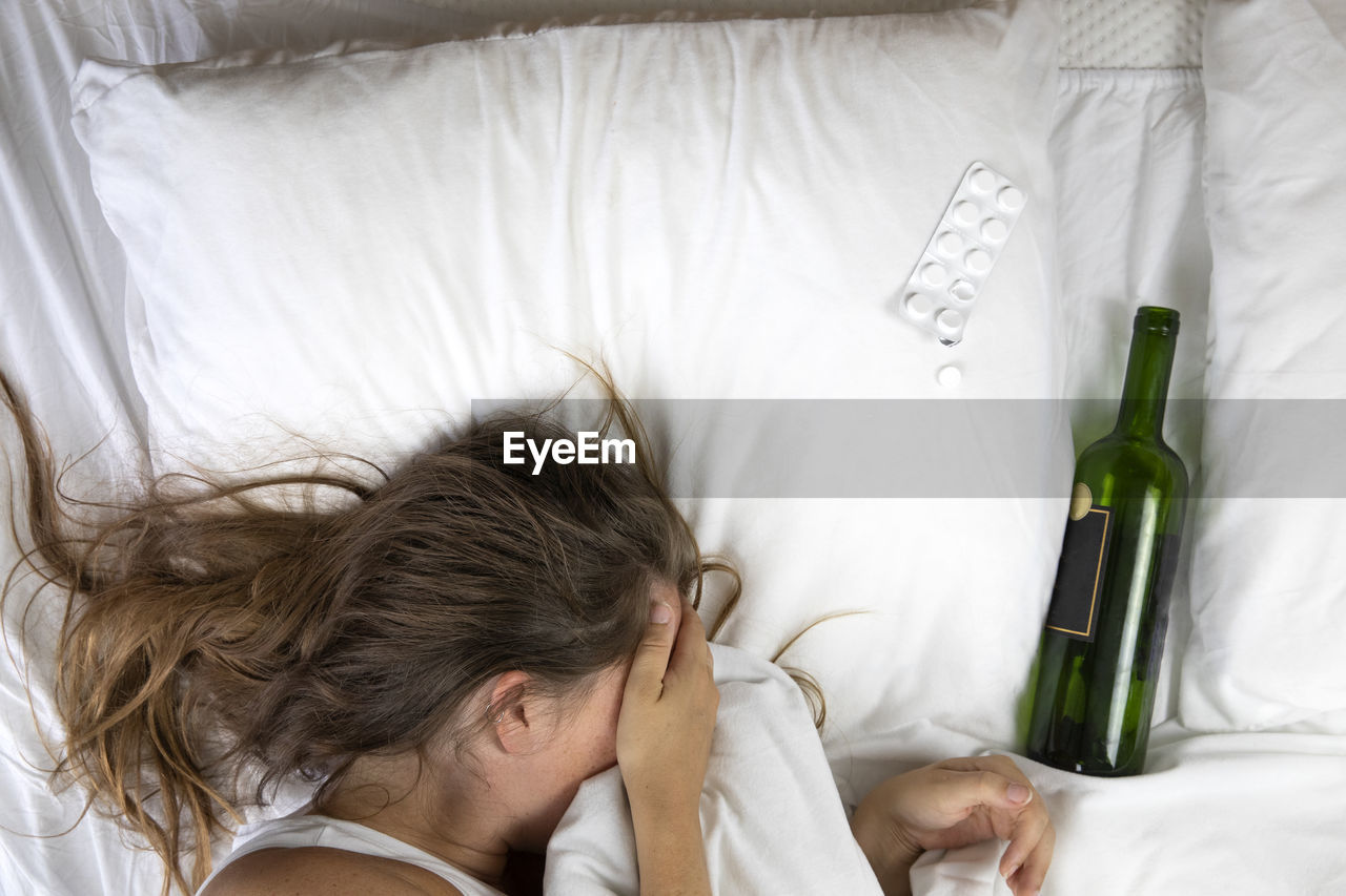 HIGH ANGLE VIEW PORTRAIT OF WOMAN SLEEPING ON BED