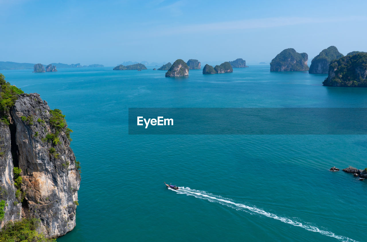 Beautiful view from above of lanscape of blue ocean and small island with boat riding in summer