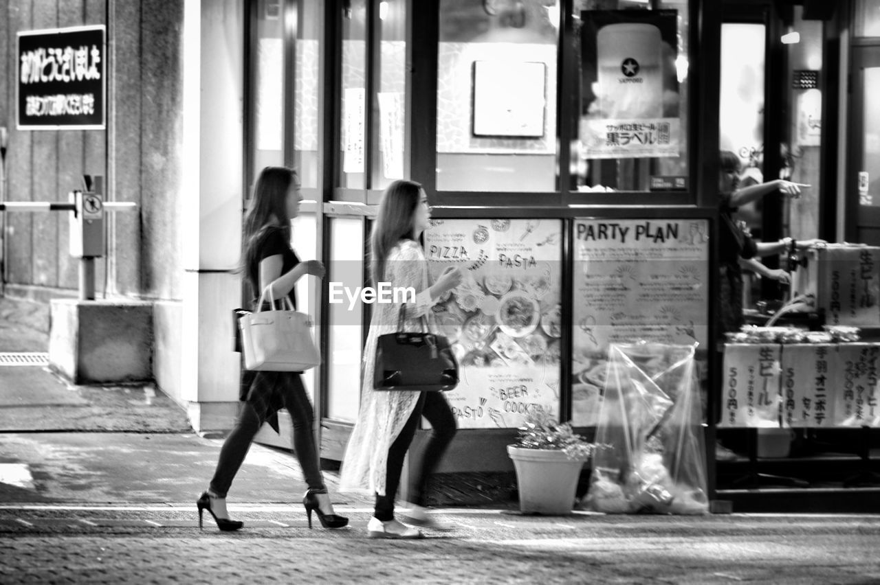 WOMEN STANDING AT STORE