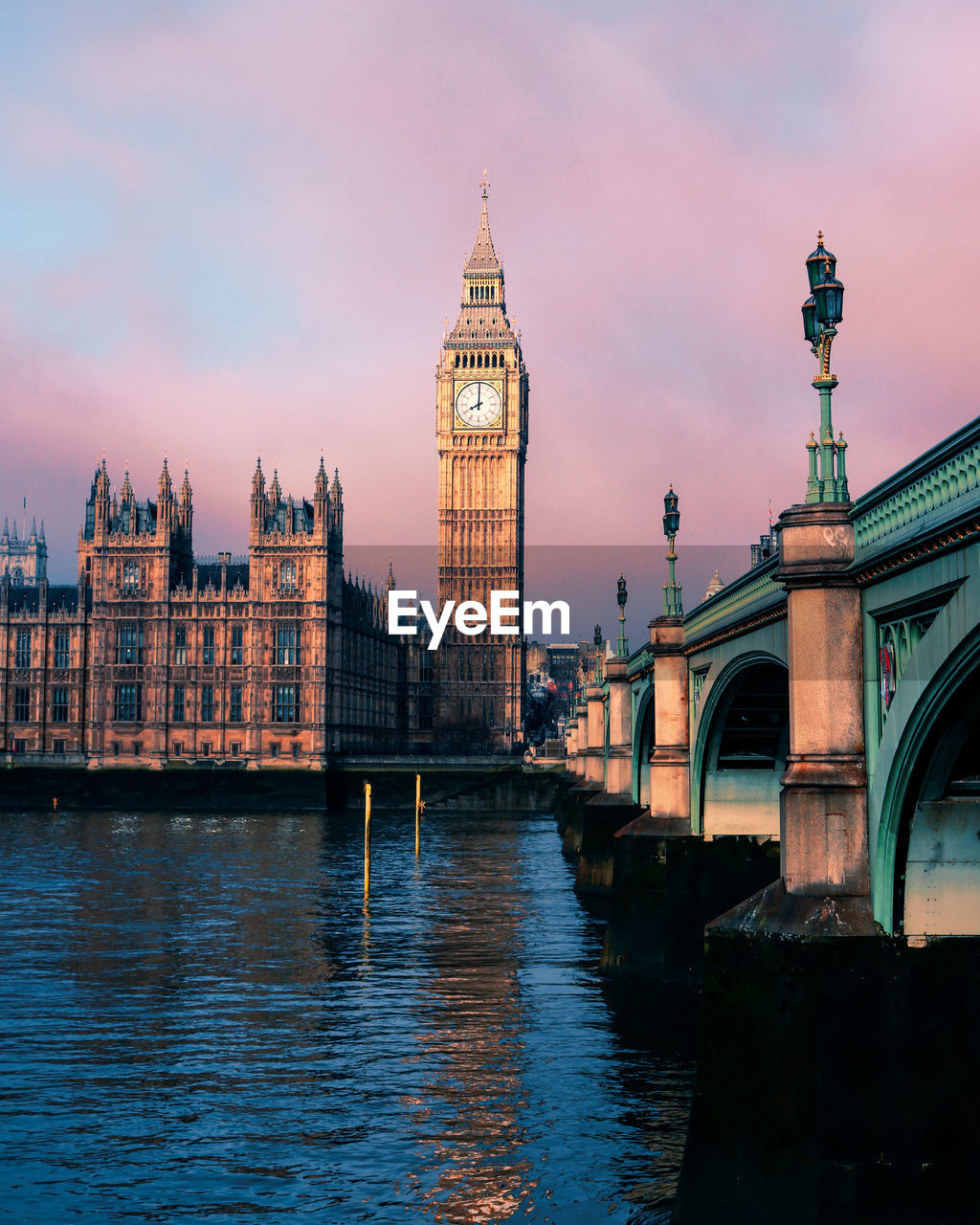 Westminster bridge over thames river against big ben