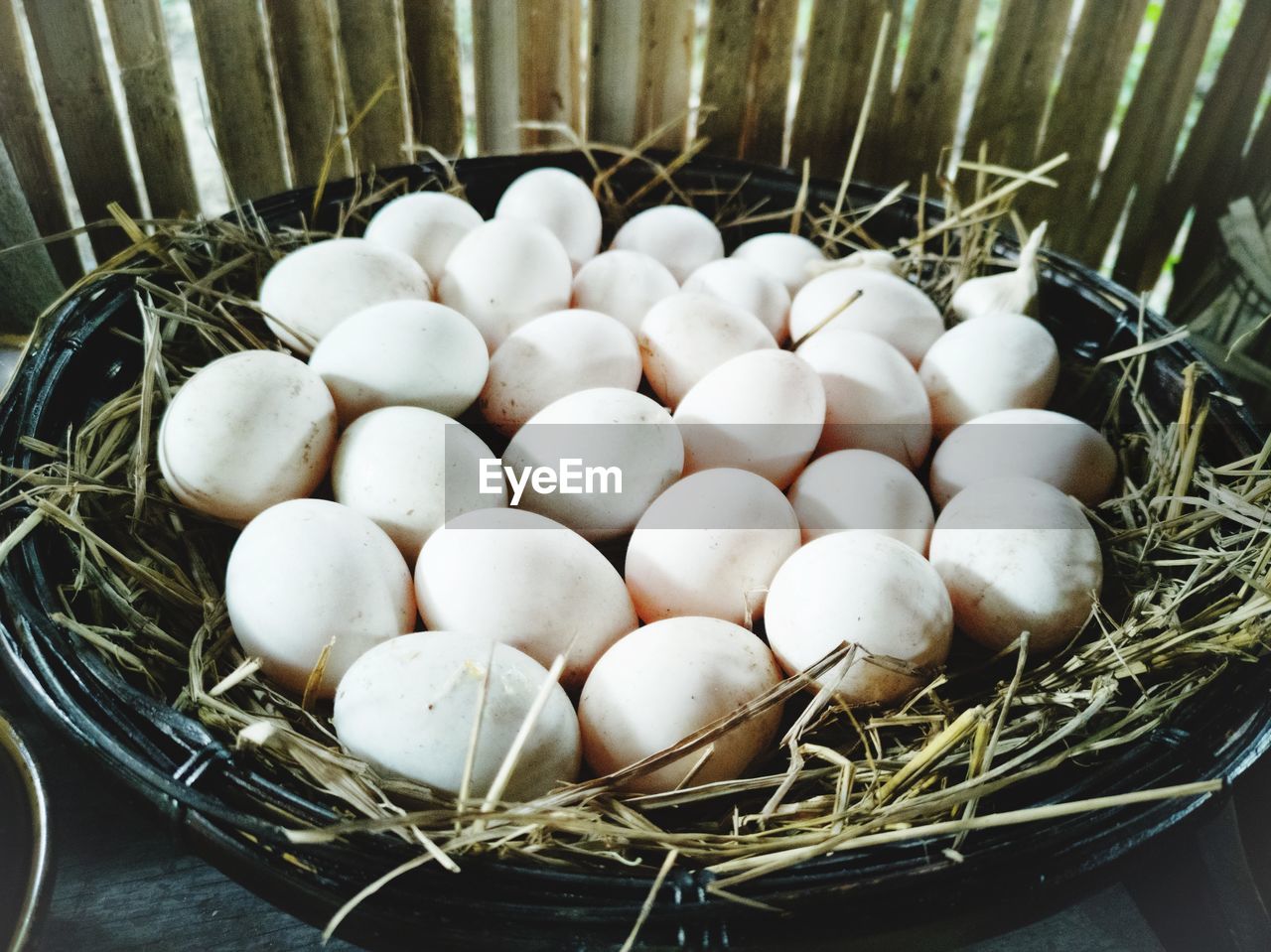 HIGH ANGLE VIEW OF EGGS IN BASKET ON FLOOR