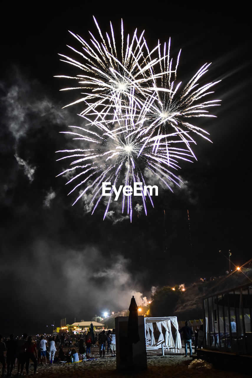 Low angle view of firework display at night