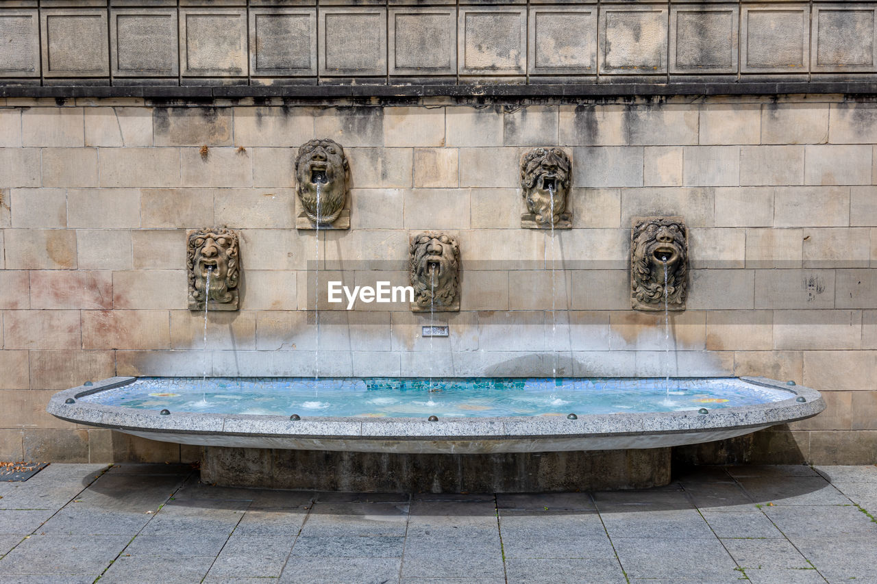 Luxembourg  city, in this photo gargoyles in the wall that spit their water into a small water bath