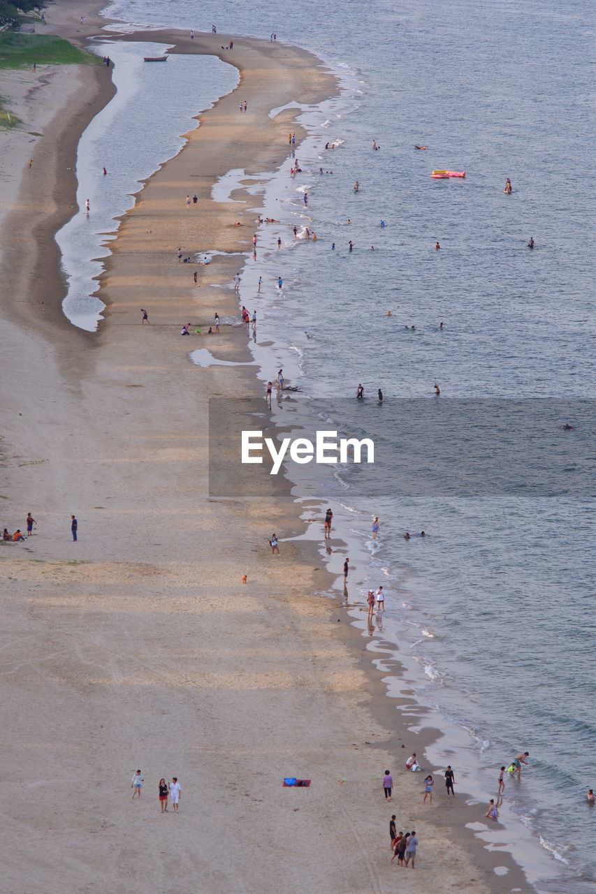 HIGH ANGLE VIEW OF PEOPLE ENJOYING AT BEACH