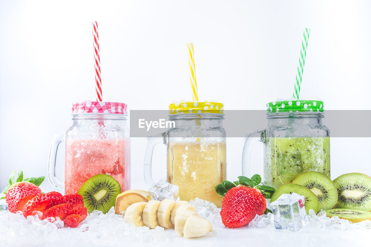 food and drink, food, healthy eating, fruit, soft drink, berry, wellbeing, strawberry, freshness, drinking straw, straw, container, produce, jar, studio shot, no people, drink, variation, indoors, citrus fruit, red, refreshment, raspberry, kiwi, multi colored, white background, mason jar, organic, cold temperature, vitamin