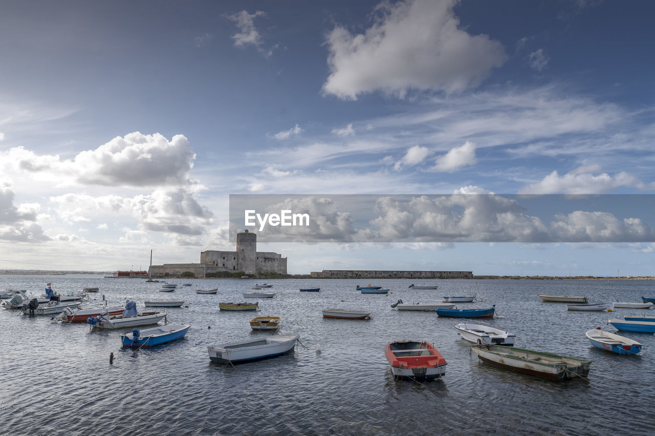 Sailboats moored on sea