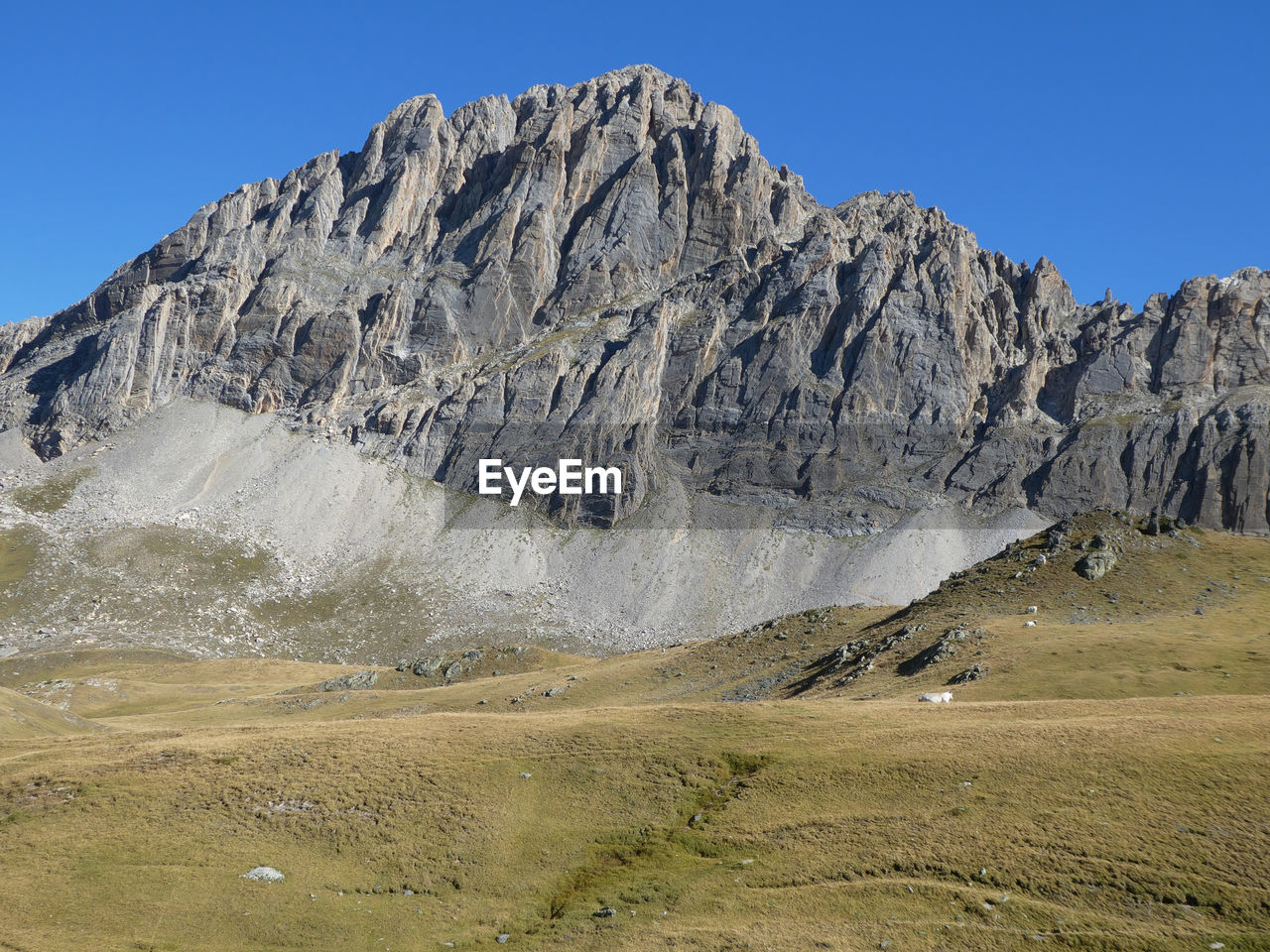 Grey mountain peak against clear blue sky near colle del preit