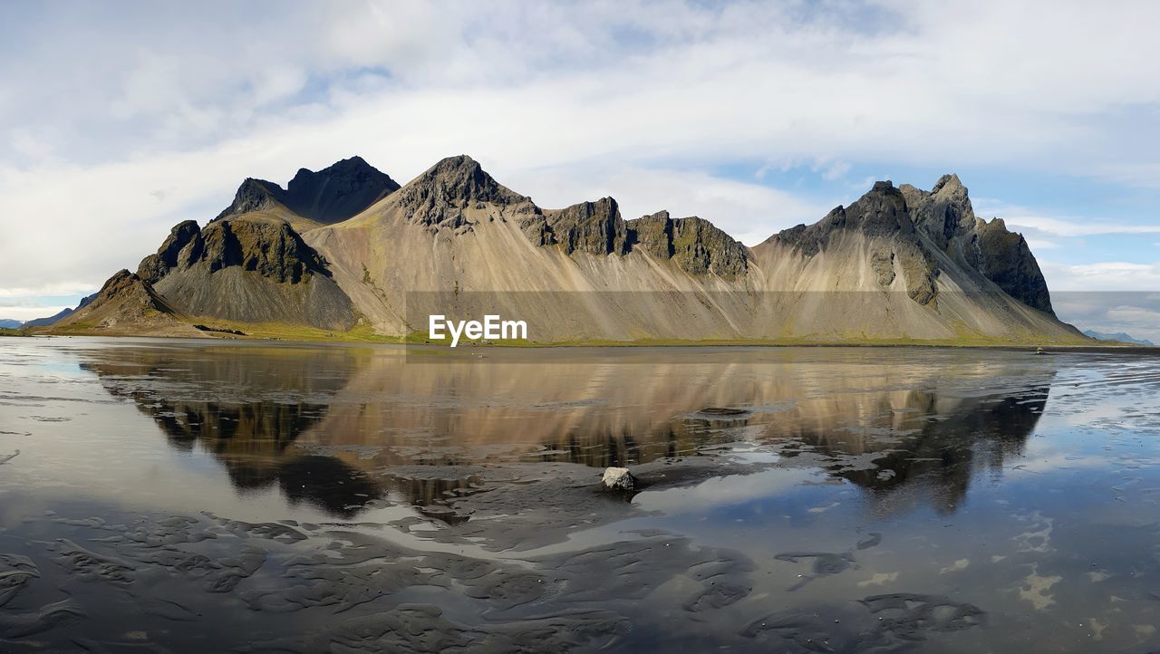 Scenic view of lake and mountains against sky