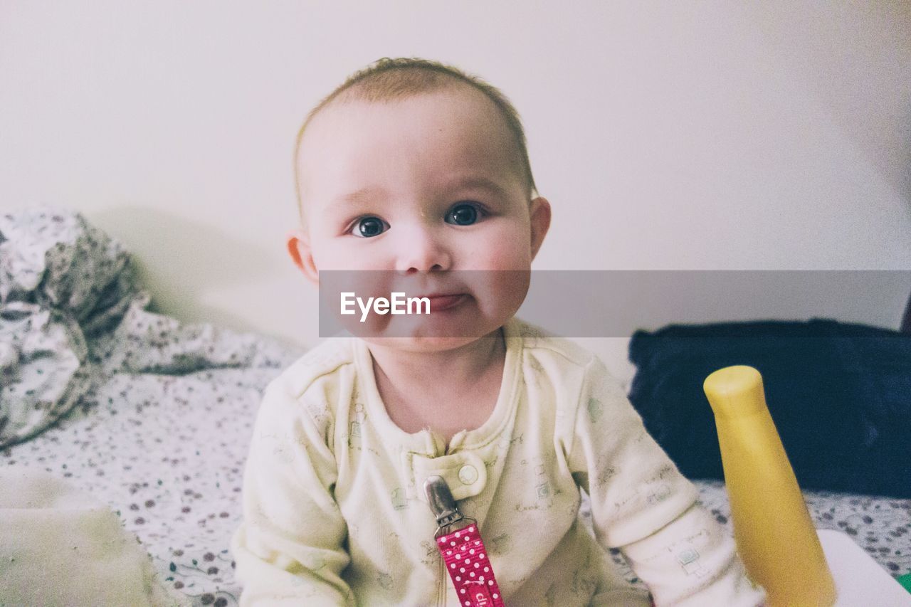 Portrait of cute baby on bed