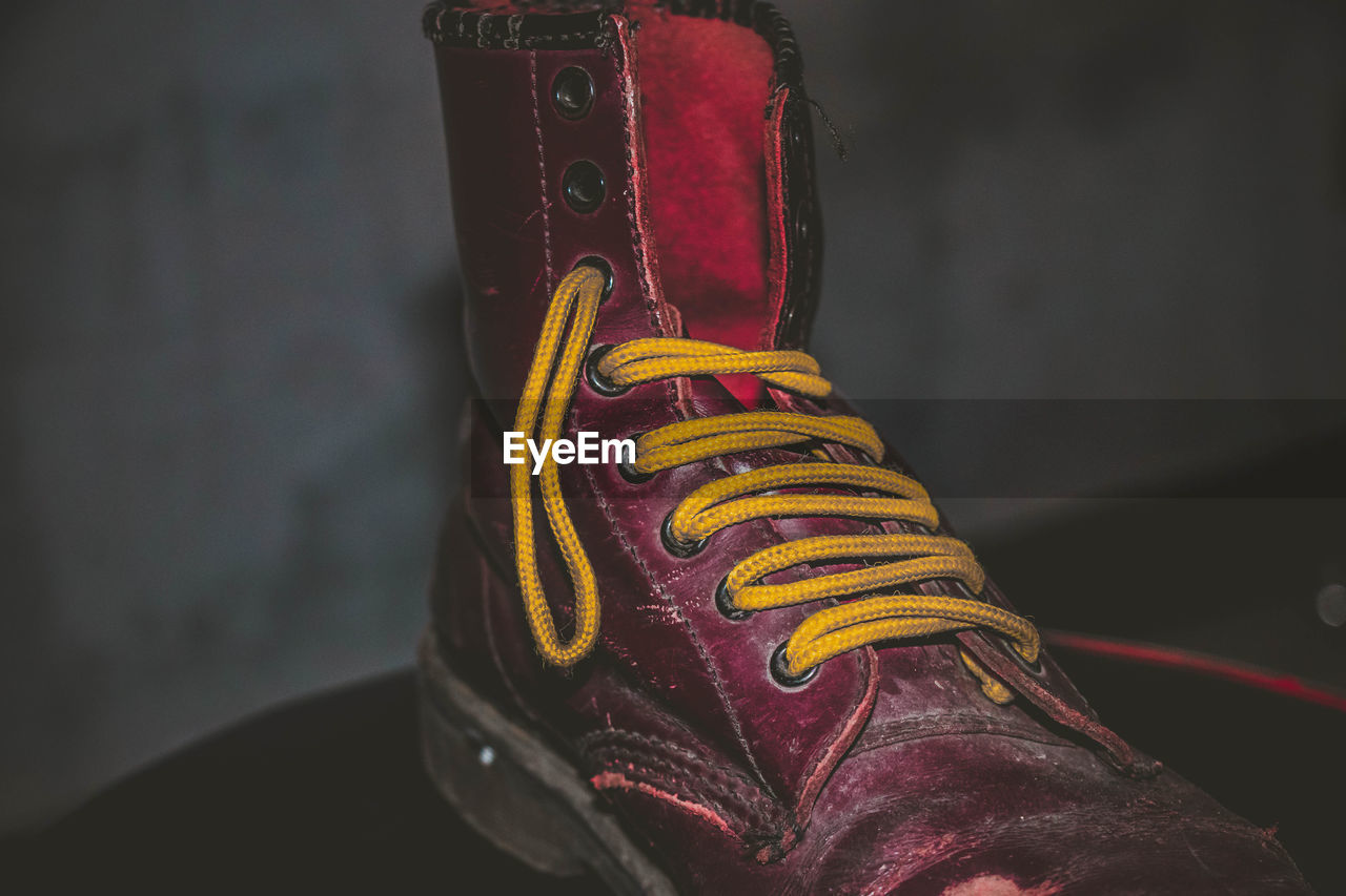 CLOSE-UP LOW SECTION OF PERSON WEARING SHOES ON FLOOR