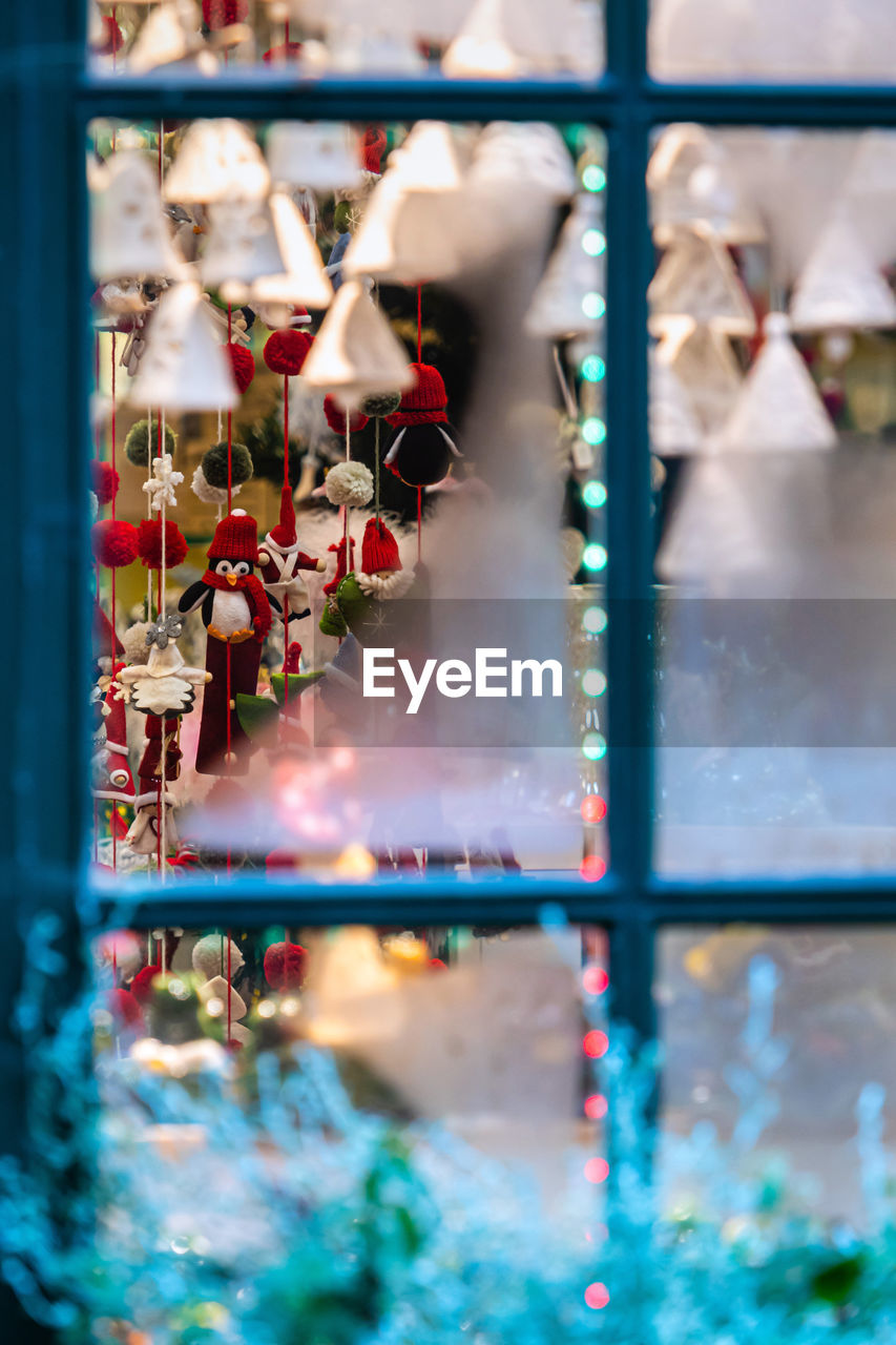 Close-up of christmas decoration seen through window