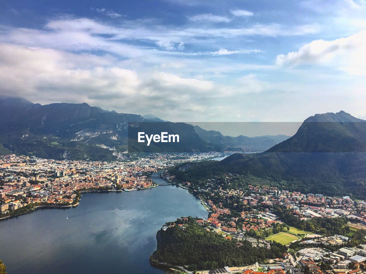 Aerial view of cityscape and mountains against sky