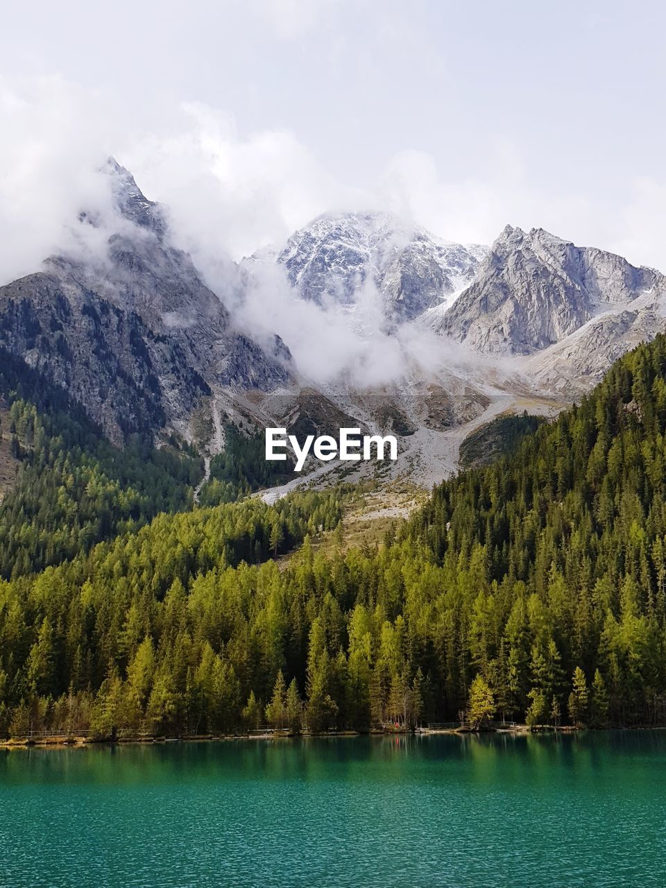 Scenic view of lake by mountains against sky