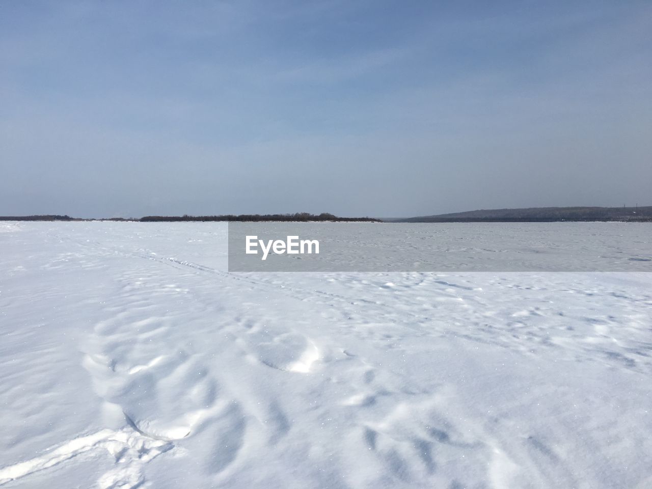 SNOW COVERED LAND AGAINST SKY