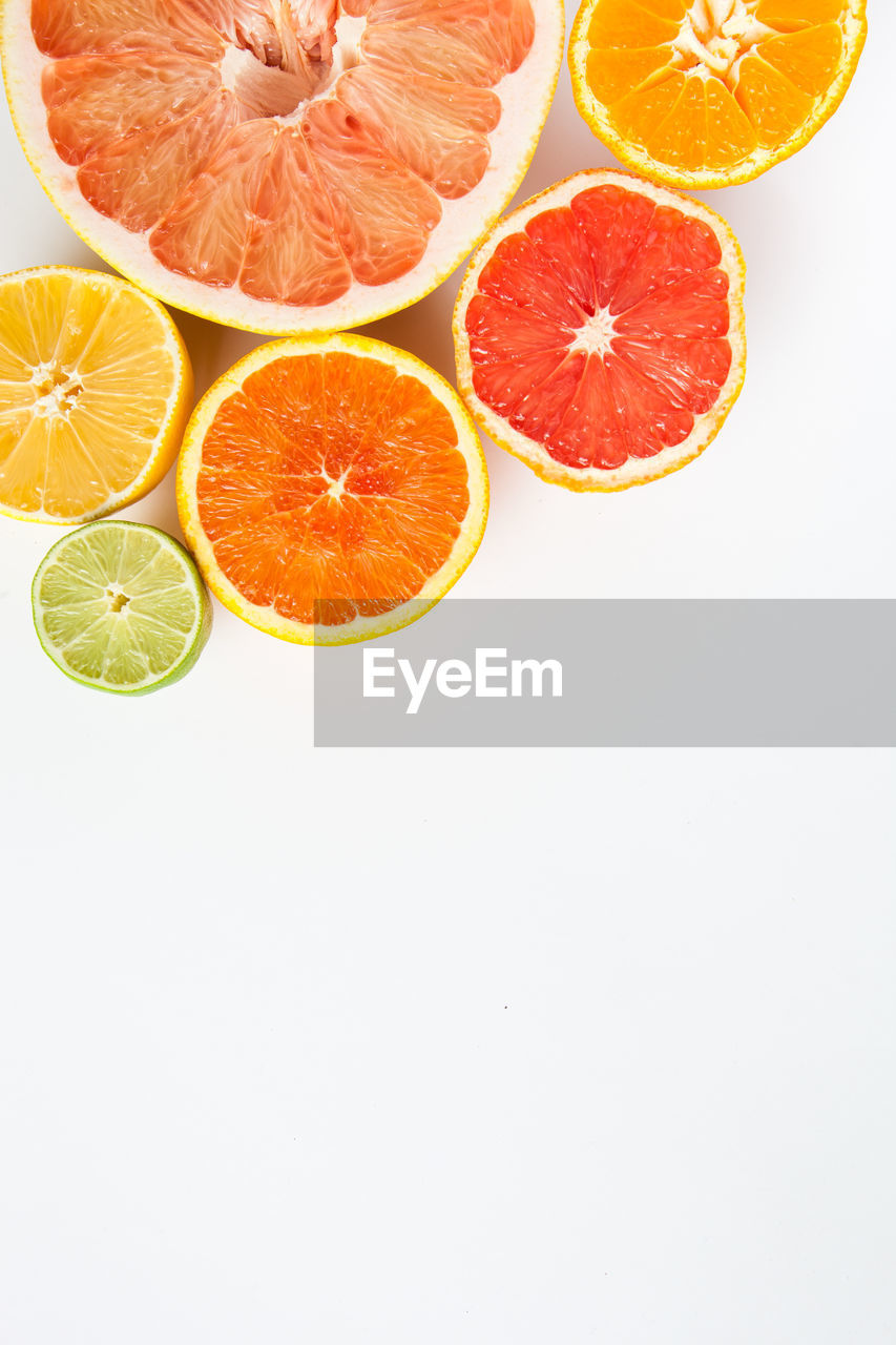 HIGH ANGLE VIEW OF FRUITS IN WHITE BACKGROUND