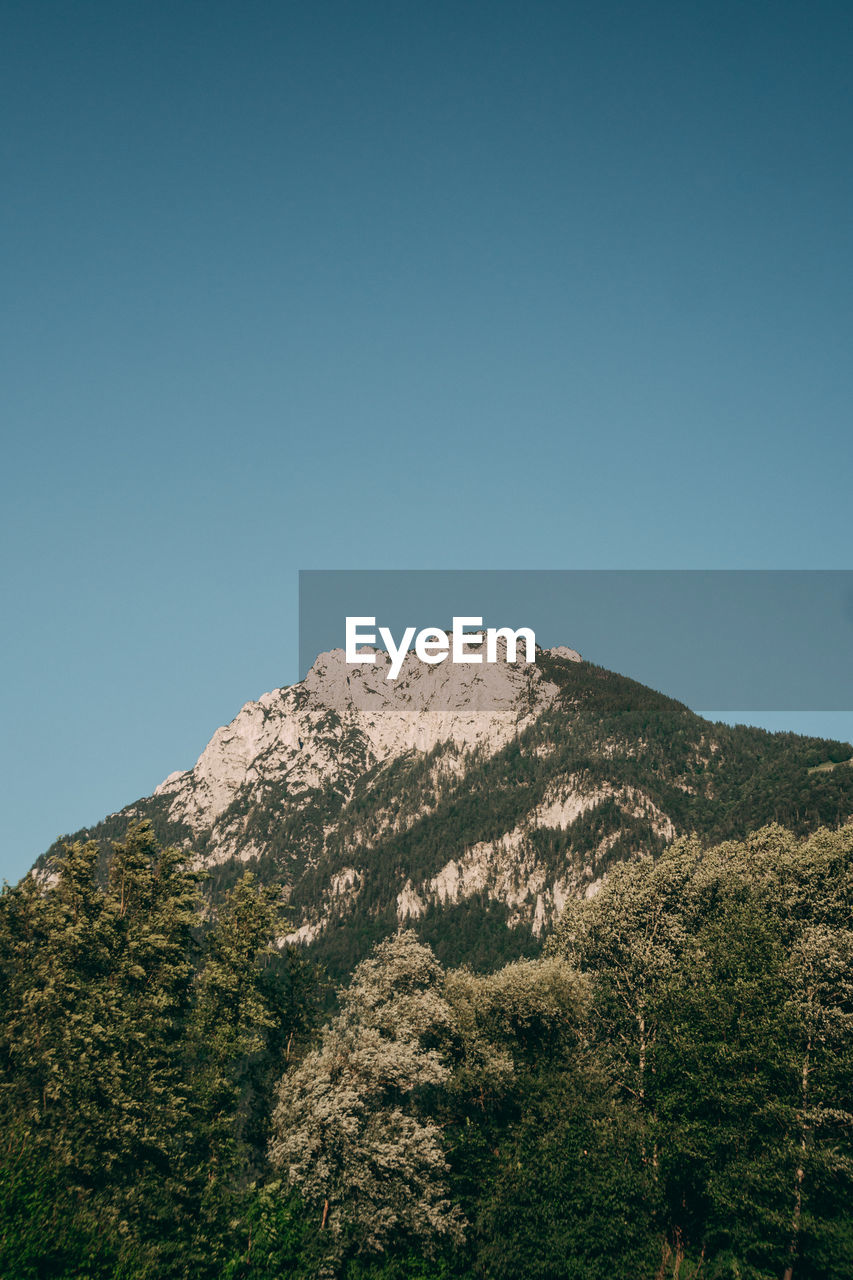 Scenic view of snowcapped mountains against blue sky