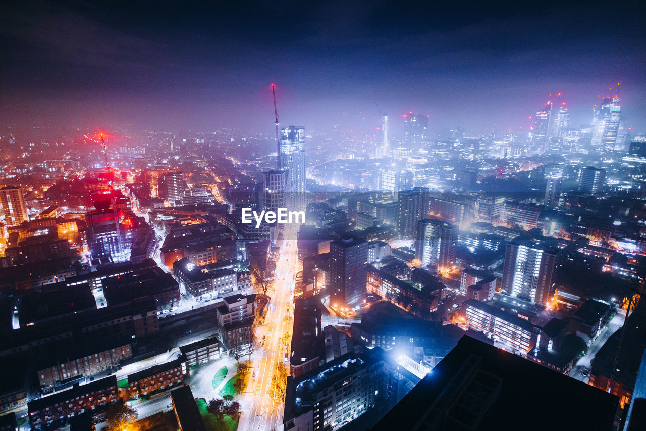 High angle view of illuminated buildings in city at night