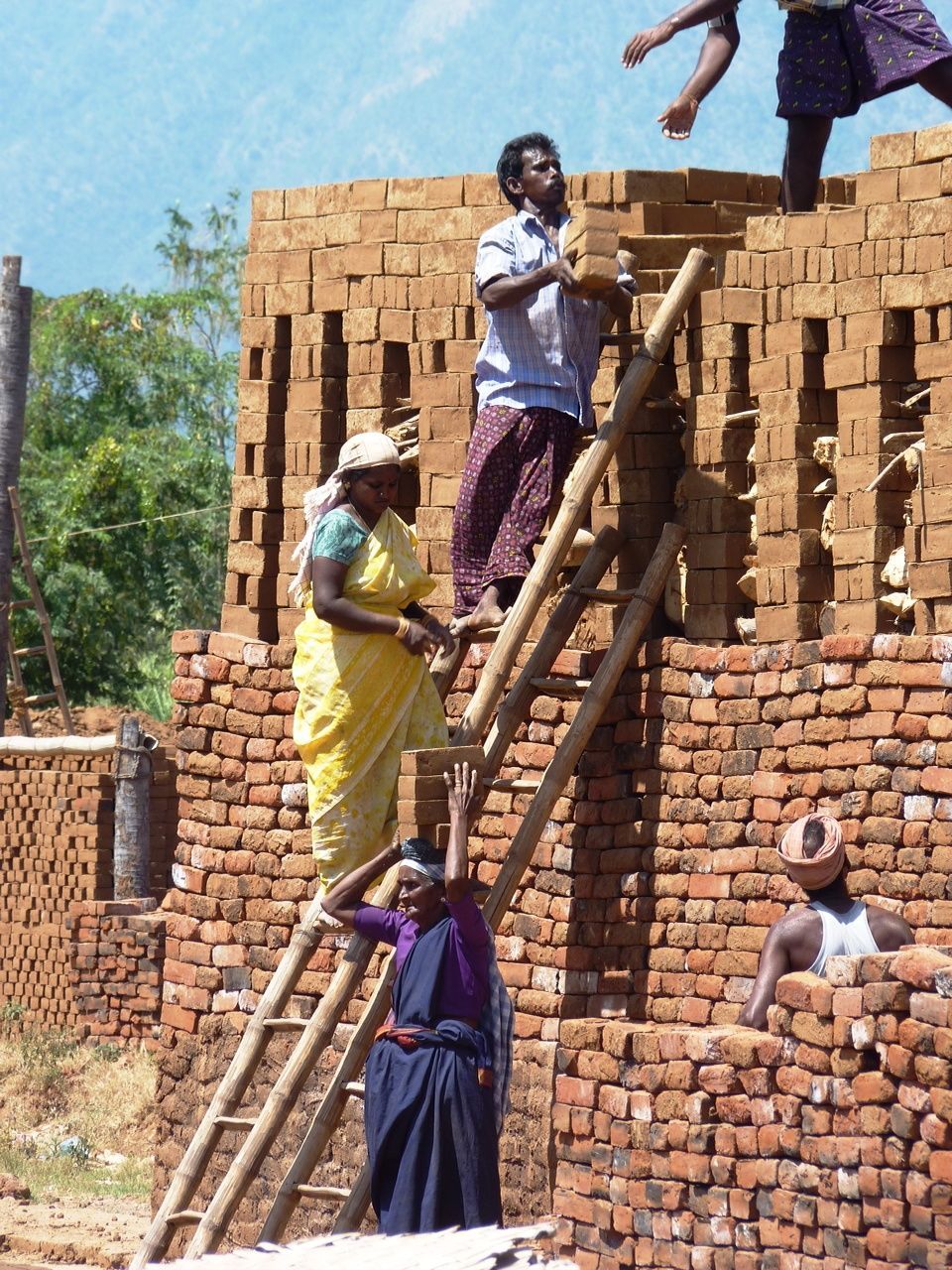 LOW ANGLE VIEW OF WOMAN STANDING ON STEPS