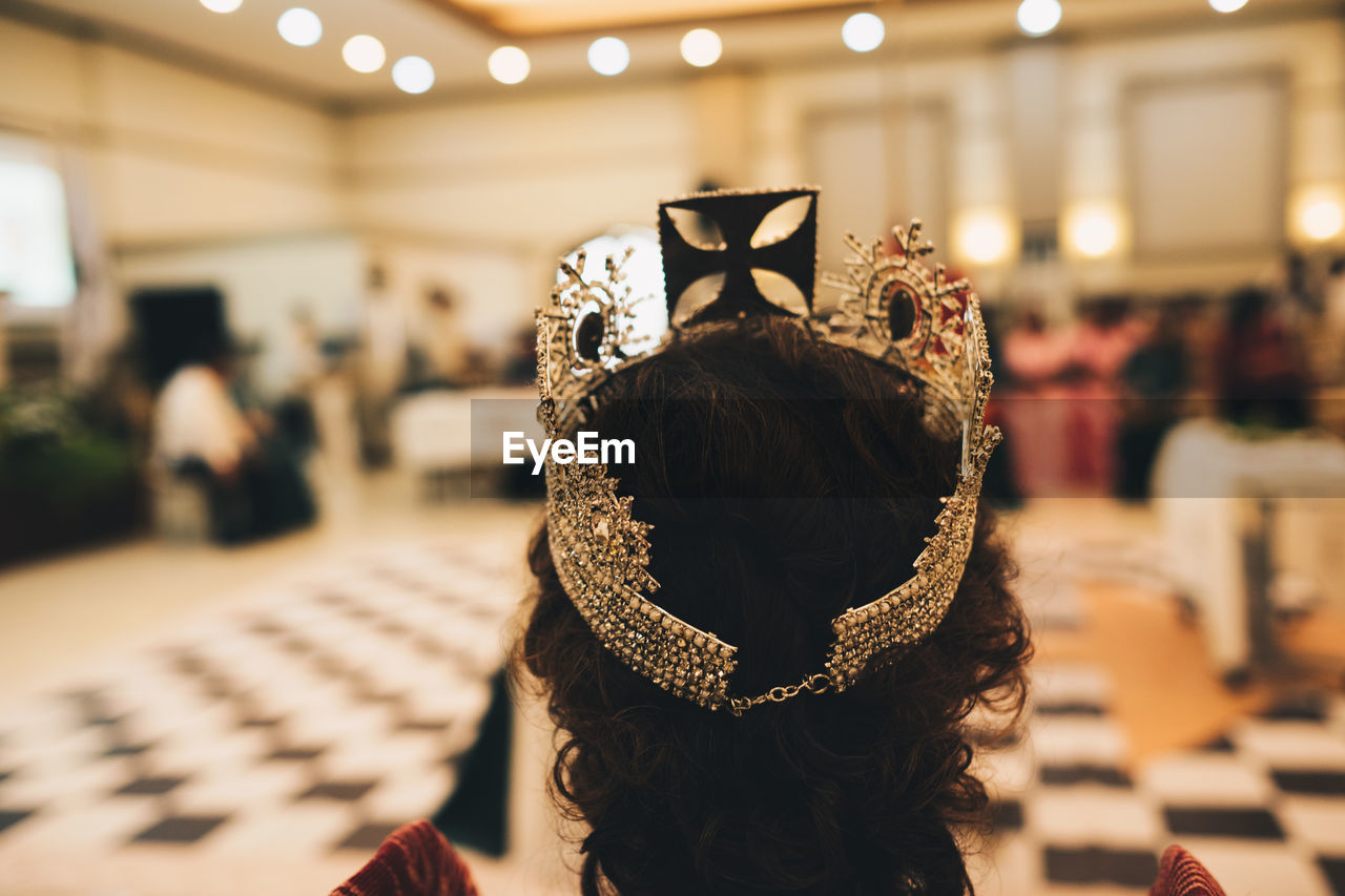 rear view of woman looking at camera