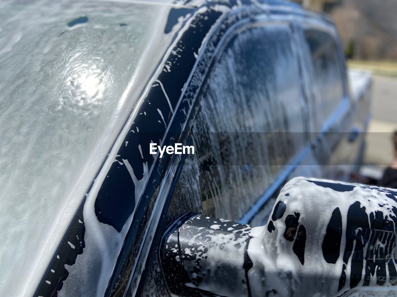 CLOSE-UP OF WET CAR WINDSHIELD