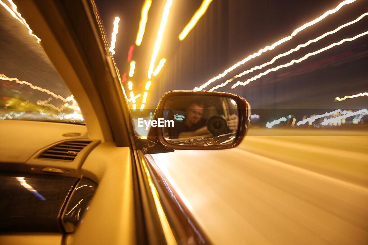 CLOSE-UP OF CAR ON ROAD AGAINST SKY