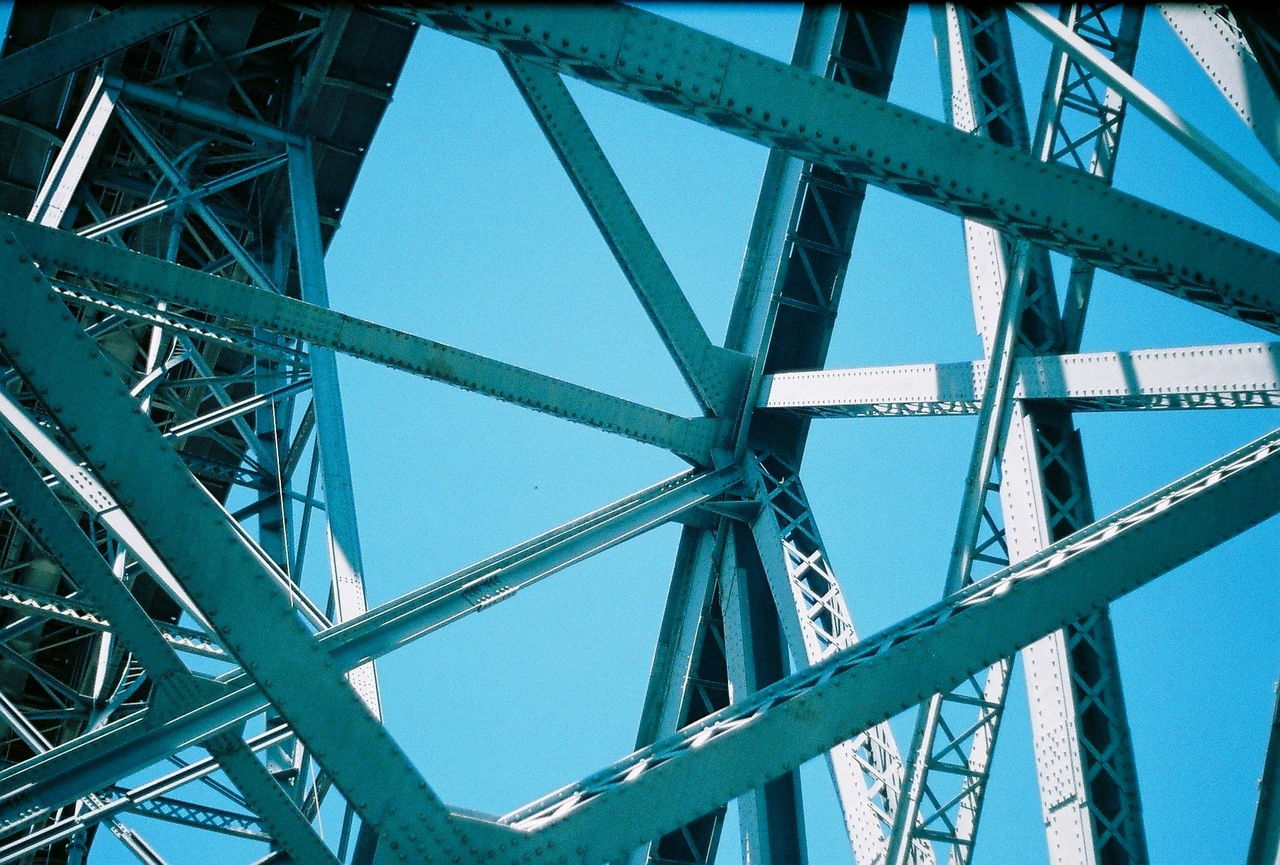 Low angle view of bridge against blue sky