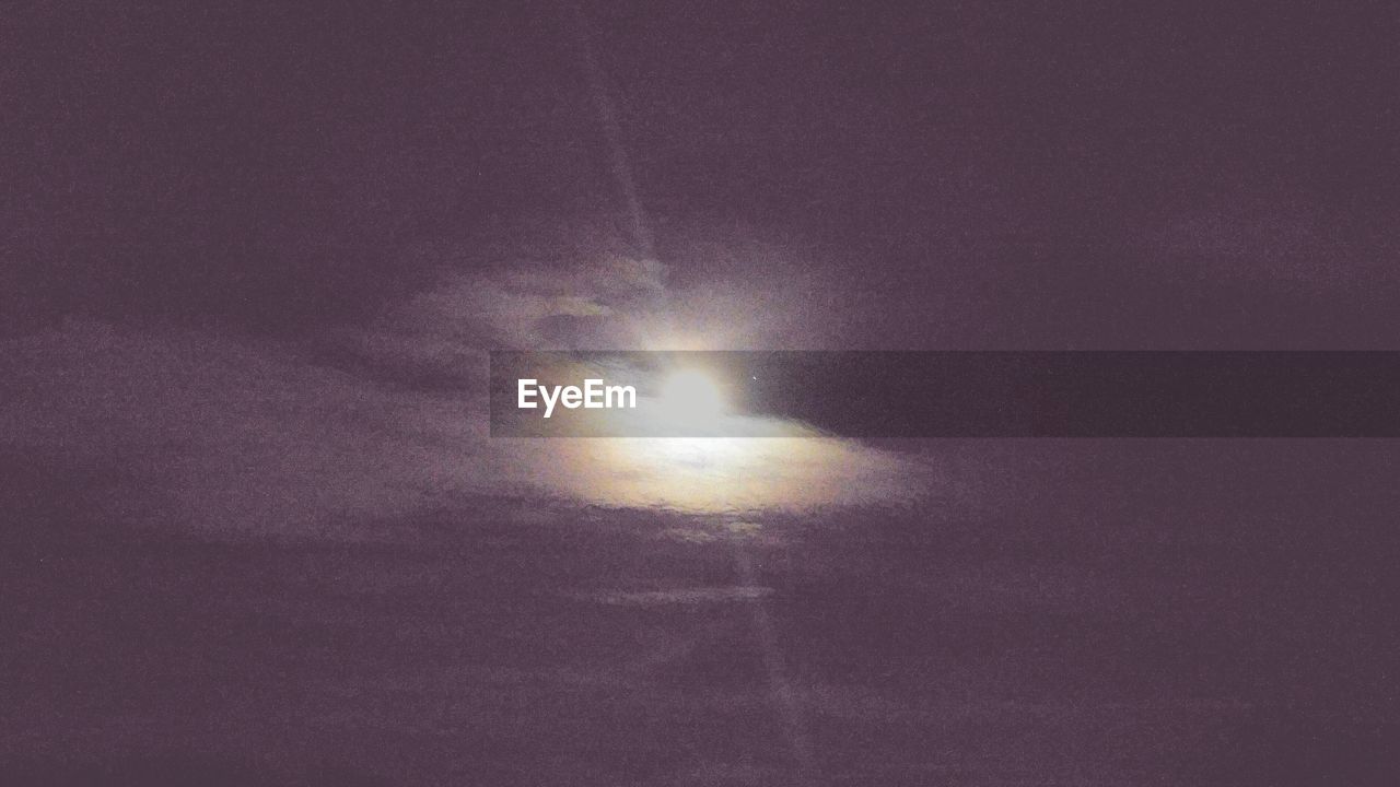 LOW ANGLE VIEW OF MOON IN SKY