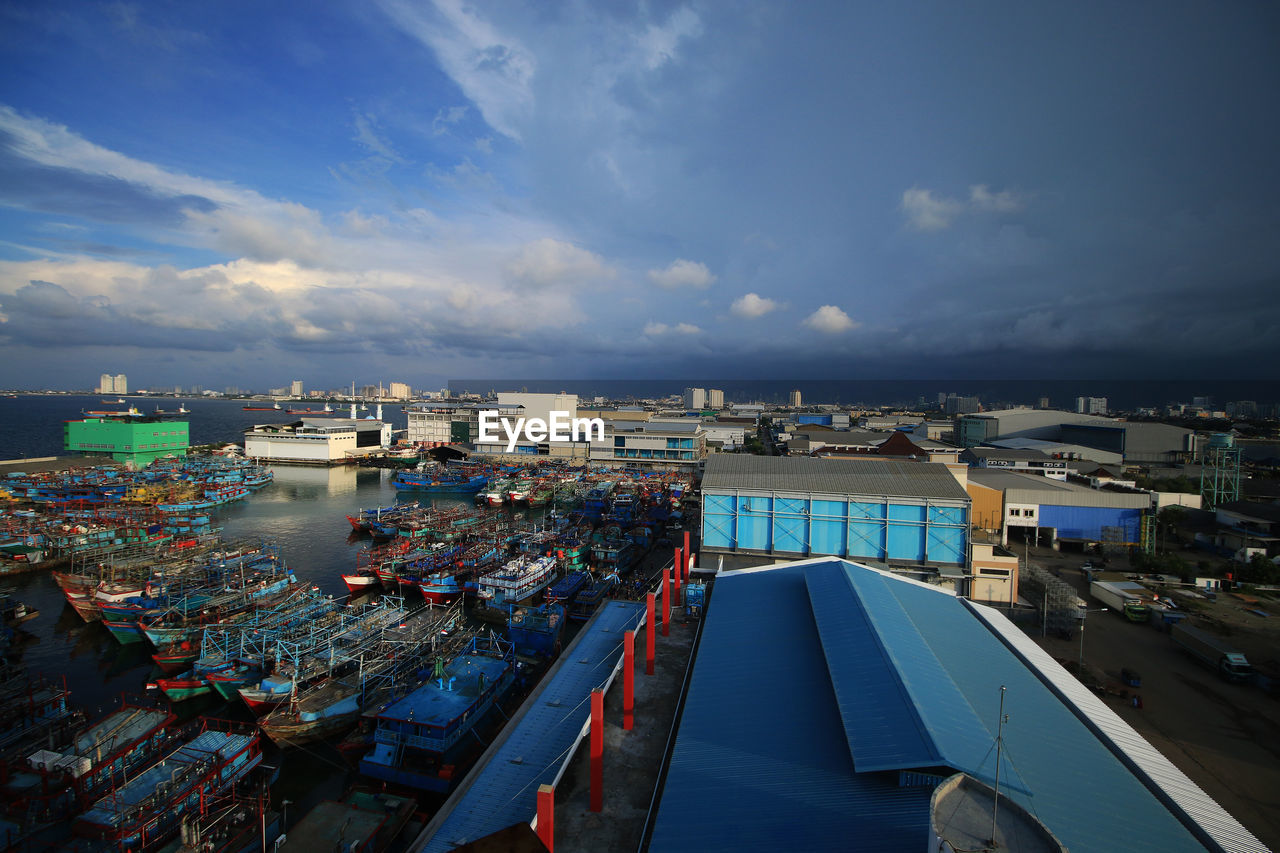 High angle view of harbor by sea against sky