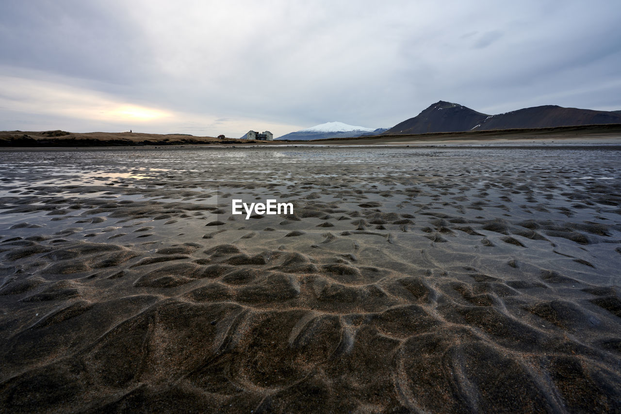 Wetland and mountains in cloudy evening