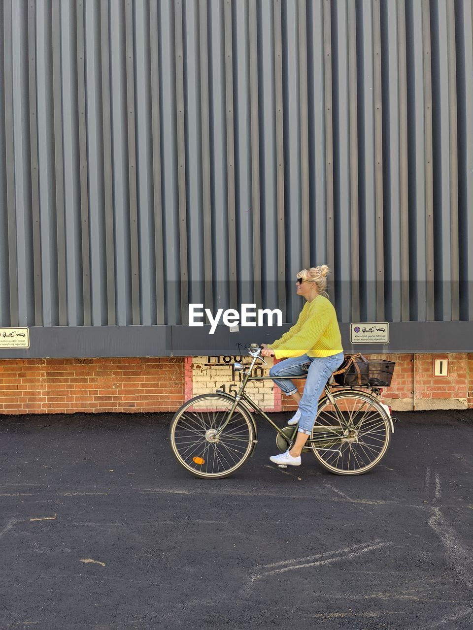 BICYCLE ON ROAD AGAINST WALL