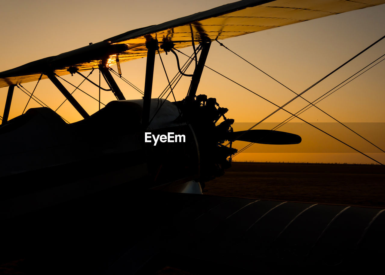 LOW ANGLE VIEW OF SILHOUETTE BOAT AGAINST SKY AT SUNSET