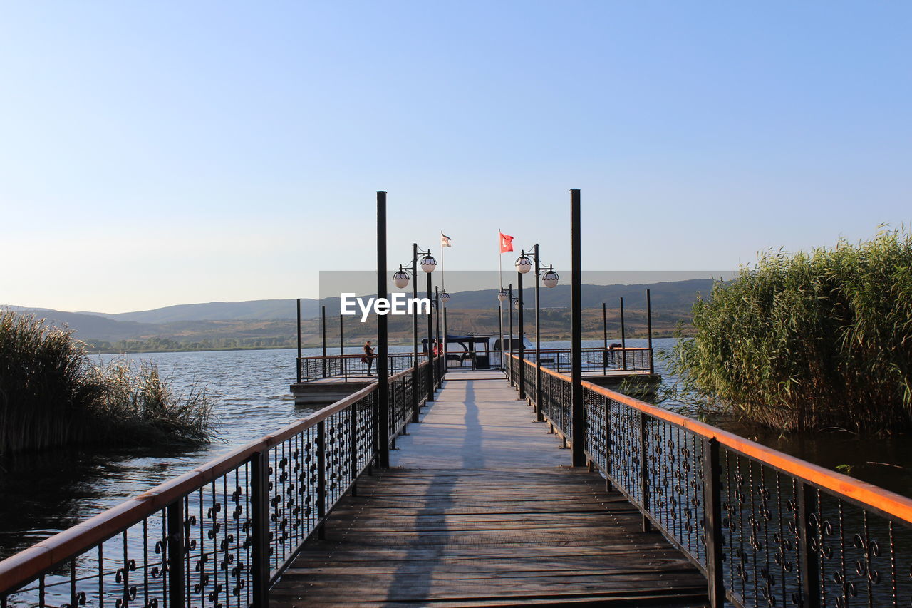 PIER ON SEA AGAINST CLEAR SKY