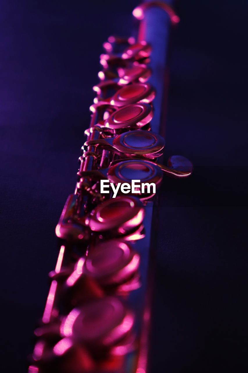 Close-up of saxophone against black background