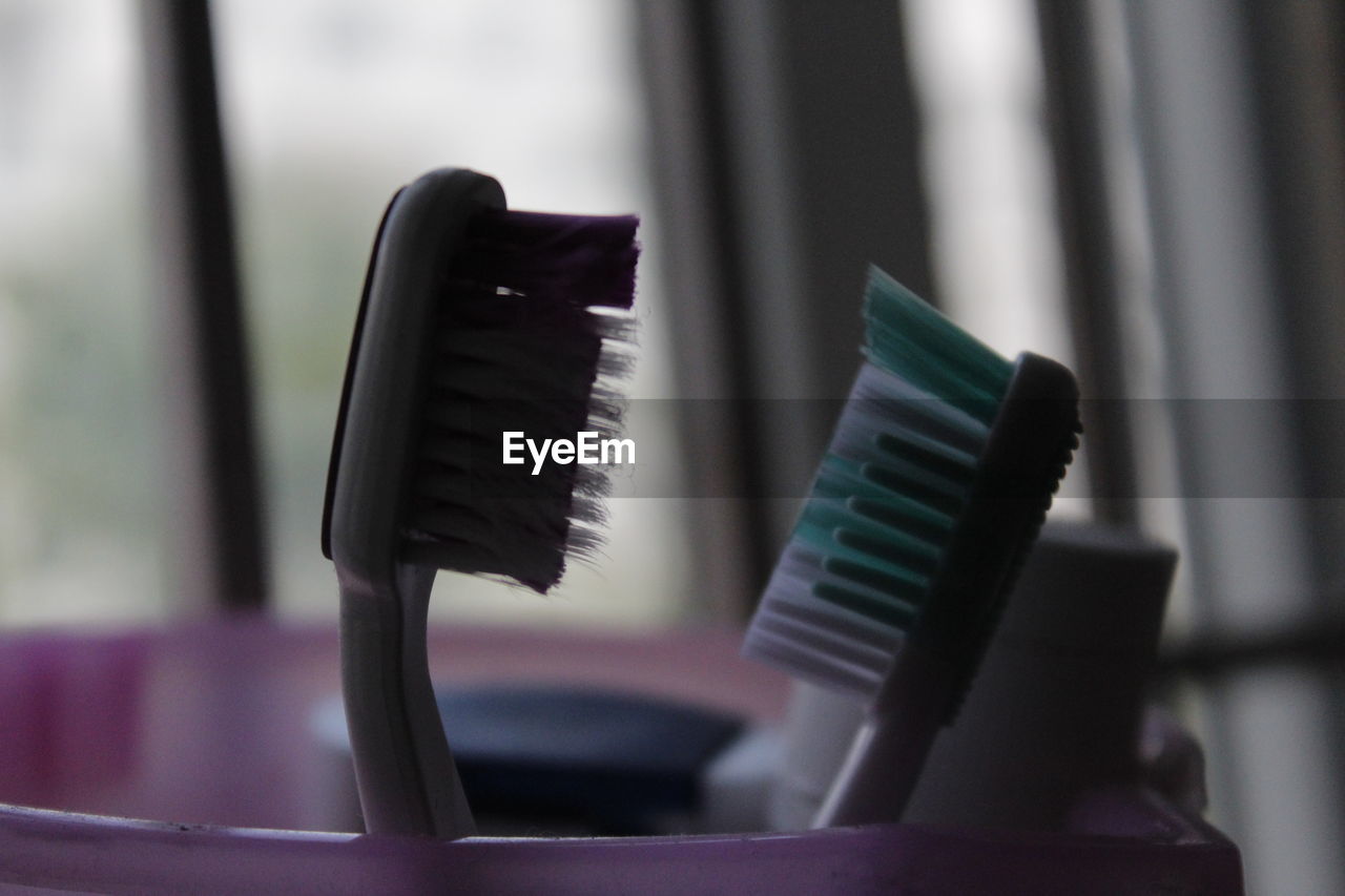 Close-up of toothbrushes in container