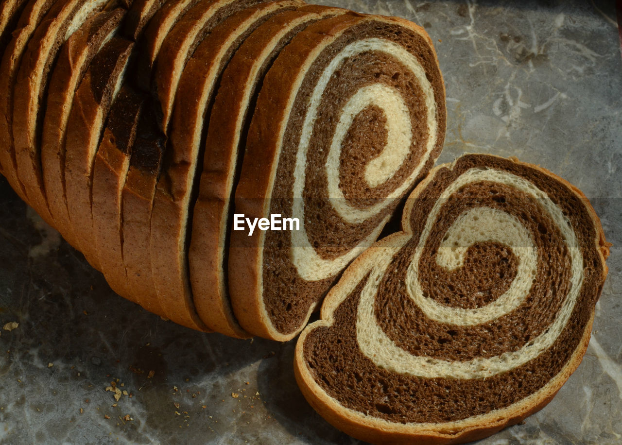 High angle view of sliced marble rye bread on table