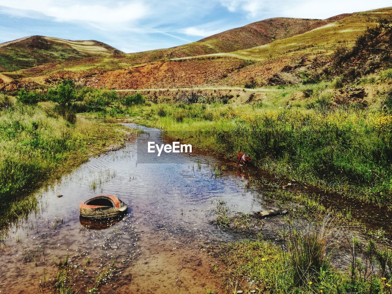 Scenic view of river amidst mountains against sky