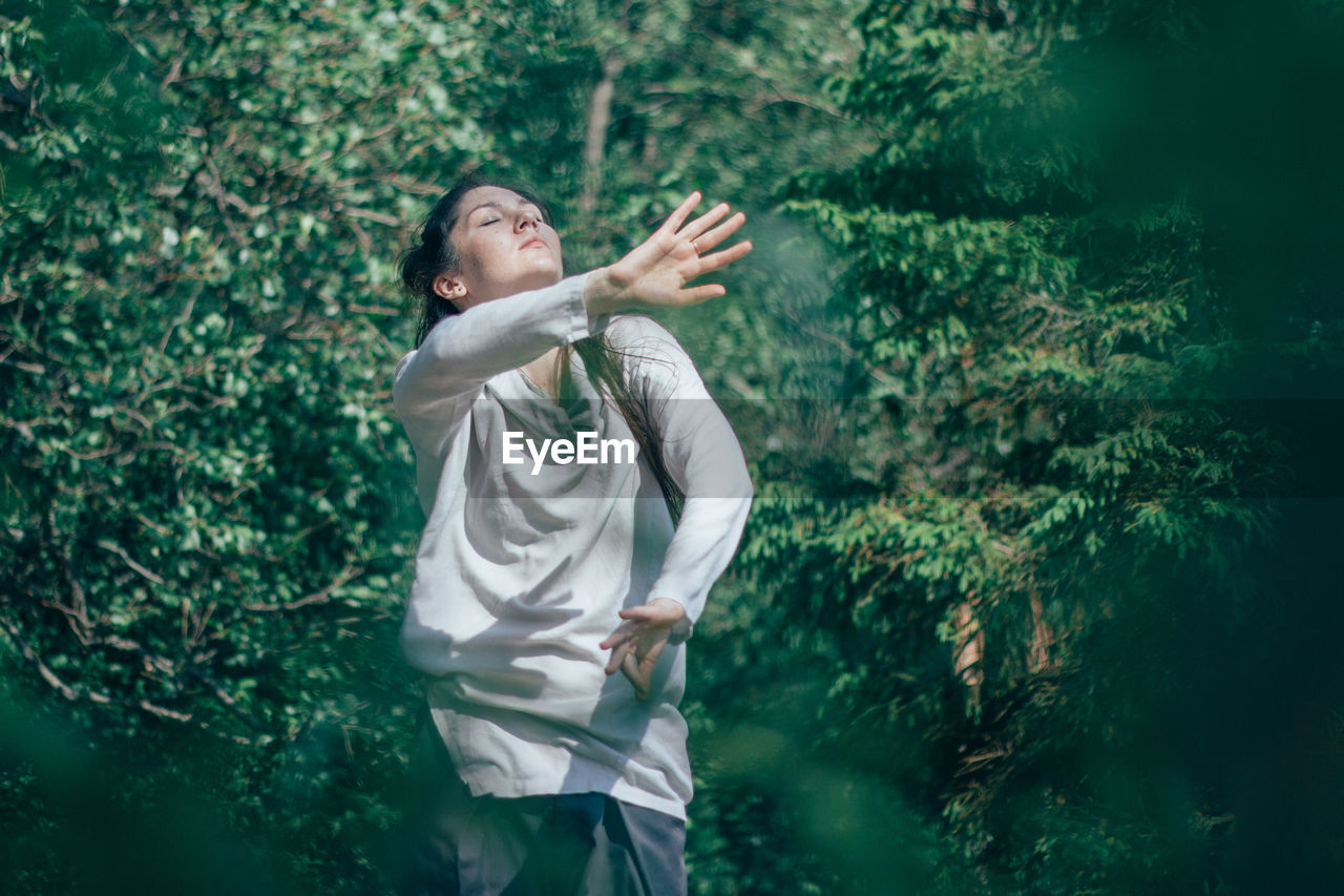 Woman dancing in forest